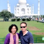 Experience the best way to see the Taj Mahal with your loved one, creating unforgettable memories against this stunning backdrop. A couple smiles for a photo in front of the Taj Mahal, showcasing the best way to see this iconic monument